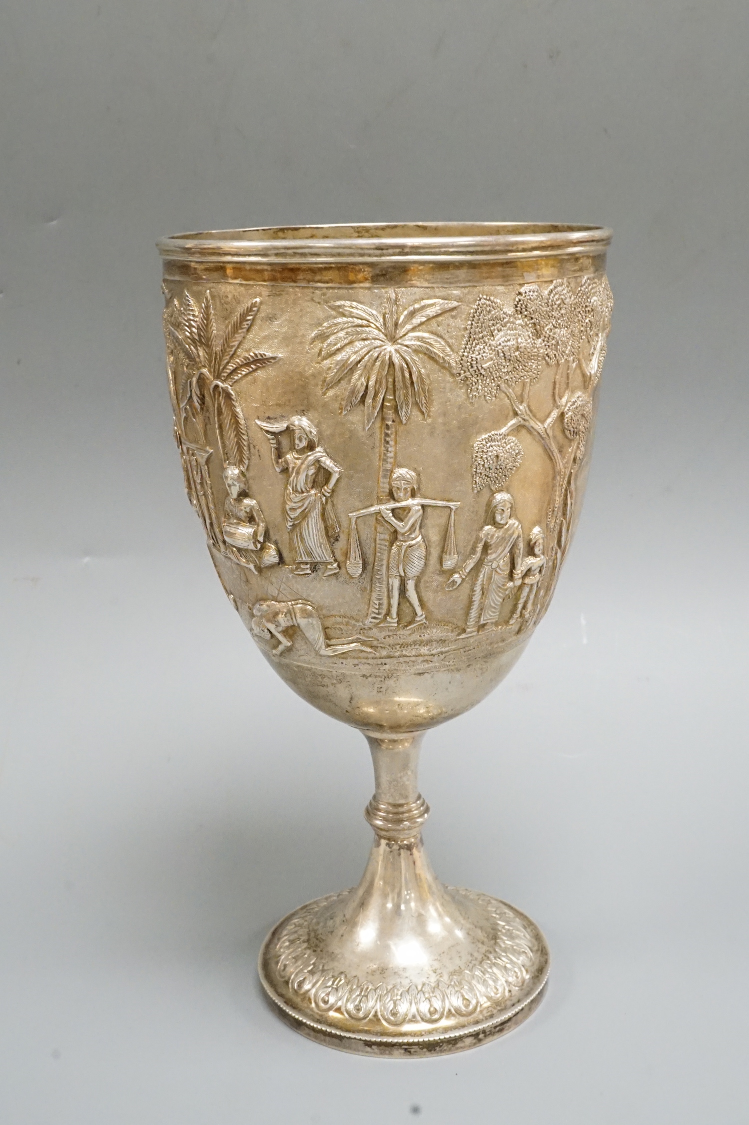 A 19th century Indian embossed white metal presentation goblet, with engraved inscription, 22.7cm, 14.7oz.
